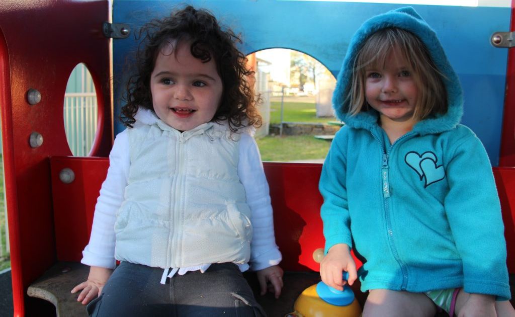 Shya-Rose Thompson with friend Lucy Williams tried to stay out of the wind yesterday at Leslie Park. 